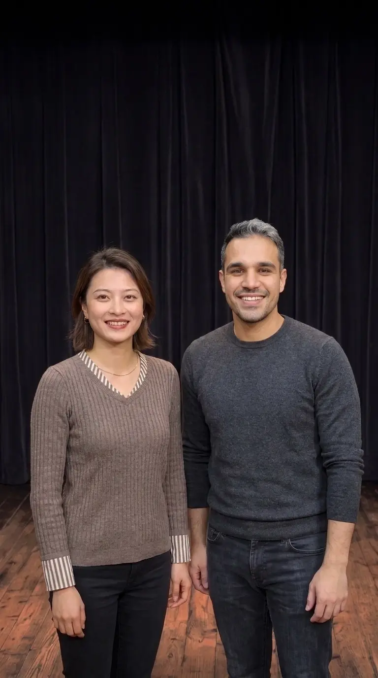 Poppy and Dave standing side by side on a dark improv stage