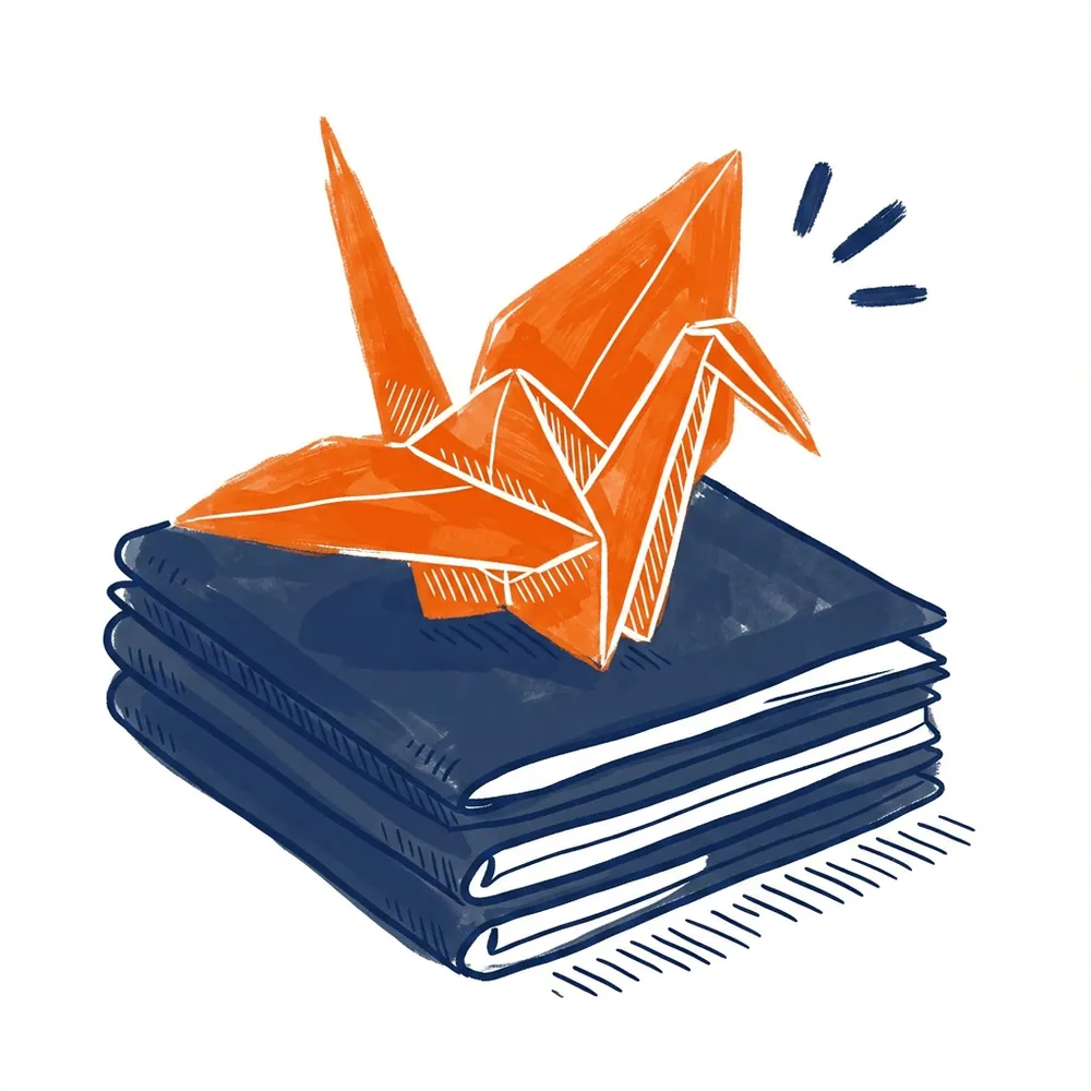 An orange origami crane perched on a folded stack of navy-blue paper
